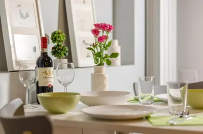 a table with a bottle of wine and glasses at VIP Apartments Sofia in Sofia