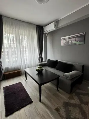 a living room with a couch and a coffee table at Apartment Alex in Sandanski