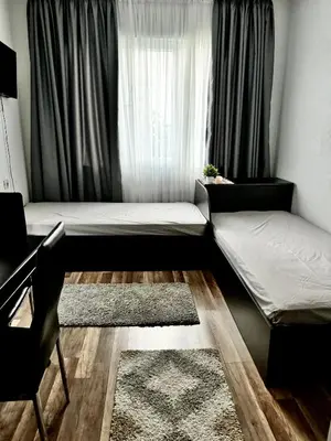 a room with two beds in front of a window at Apartment Alex in Sandanski