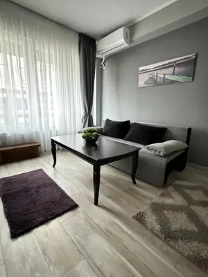 a living room with a couch and a coffee table at Apartment Alex in Sandanski