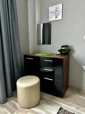 a room with a desk with a stool and a mirror at Apartment Alex in Sandanski
