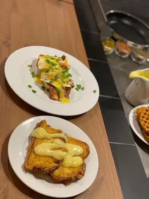two plates of food on a wooden table at Flora Hotel - Apartments in Borovets
