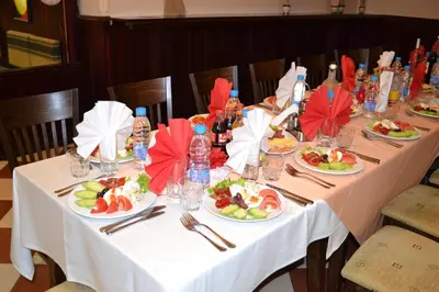 a long table with plates of food on it at Flora Hotel - Apartments in Borovets