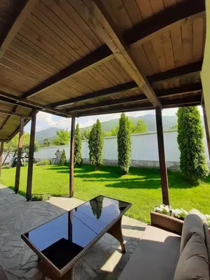 a patio with a table and a view of a yard at Villa Gardenia in Sapareva Banya