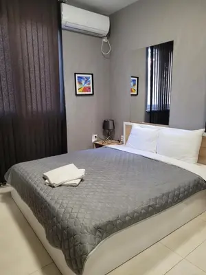 a bedroom with a bed with a towel on it at Studio M in Plovdiv