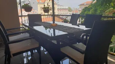 a black table and chairs on a balcony at Roman Stadium Apartments in Plovdiv