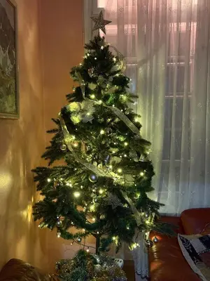 a christmas tree with lights on it in a room at Roman Stadium Apartments in Plovdiv