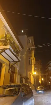 a car parked in front of a building at night at Roman Stadium Apartments in Plovdiv
