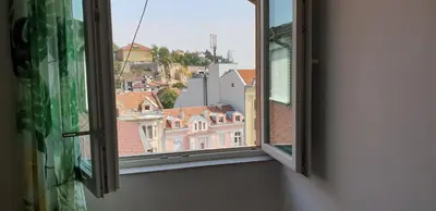an open window with a view of buildings at Roman Stadium Apartments in Plovdiv