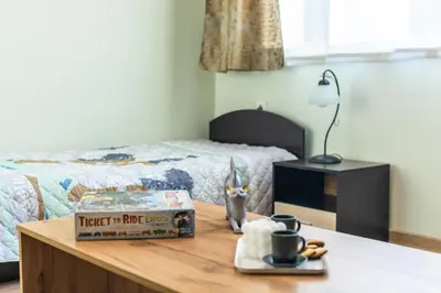 a bedroom with a bed and a table with a box of food at Madrid 90 Sq M 2BDR w Parking Spot near Metro, Serdika Mall in Sofia
