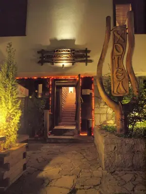 an entrance to a building with stairs and a sign at Momini Dvori Boutique Guest House in Bansko