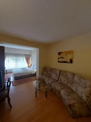 a living room with a couch and a bed at Elegant Complex in Pazardzhik