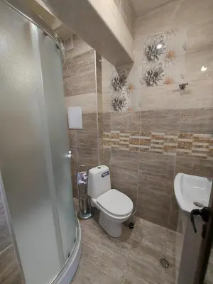 a bathroom with a toilet and a sink at Elegant Complex in Pazardzhik