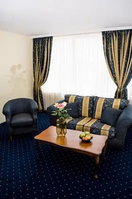 a living room with a couch and a coffee table at Park Hotel Sankt Peterburg in Plovdiv