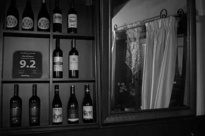 a bunch of bottles of wine in a cabinet at Guest House Verbena in Apriltsi