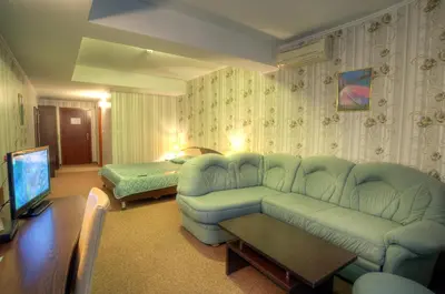 a living room with a couch and a bed at Luxor Hotel in Smolyan