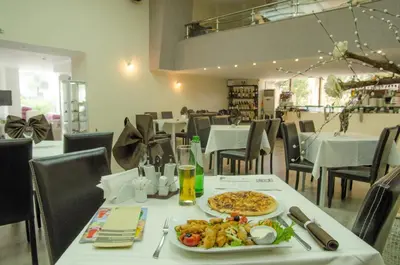 a table with a plate of food on a table at Luxor Hotel in Smolyan