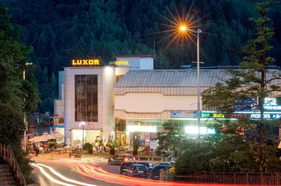 a building with a lit up sign at night at Luxor Hotel in Smolyan