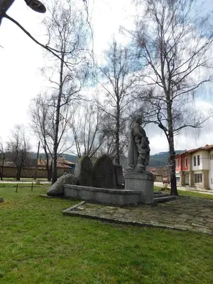 a statue of a man sitting in a park at Family Vacation Home Topolnitza in Koprivshtitsa