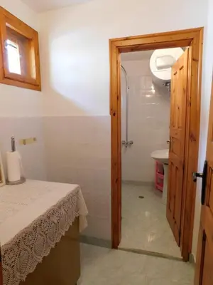 a bathroom with a toilet and a sink and a door at Family Vacation Home Topolnitza in Koprivshtitsa