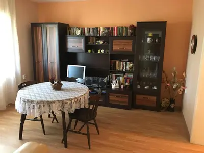a dining room with a table and a book shelf at Guesthouse Planinsko Gnezdo in Tŭzha