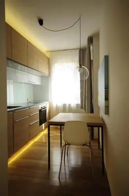 a kitchen with a table and chairs in a room at Design Apartment in Park in Sofia