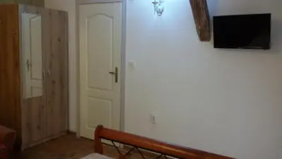 a room with a wall with a television on a wall at Guest Rooms Filipopol in Plovdiv