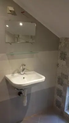 a bathroom with a white sink and a mirror at Guest Rooms Filipopol in Plovdiv