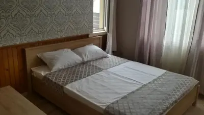 a bed with two pillows and a window in a bedroom at Guest Rooms Filipopol in Plovdiv