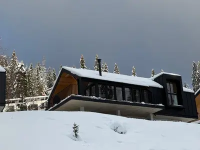 a house on top of a snow covered slope at High Five Villas in Pamporovo