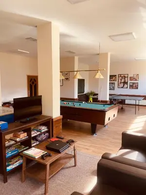 a living room with a pool table and a couch at High Five Villas in Pamporovo