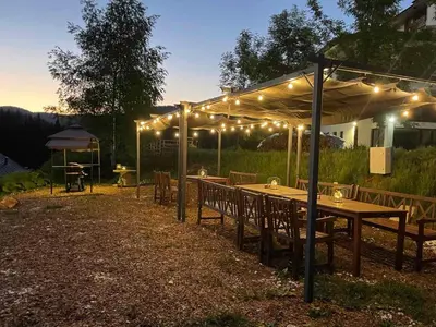 a wooden table under a tent with lights on it at High Five Villas in Pamporovo