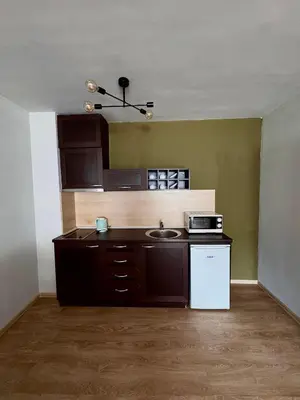 an empty kitchen with a sink and a microwave at Bansko Royal Towers Hotel in Bansko