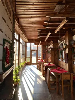 a dining room with tables and chairs in a building at Hotel Orbel in Dobrinishte