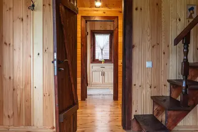 an empty hallway with a door and a window at Hotel Orbel in Dobrinishte