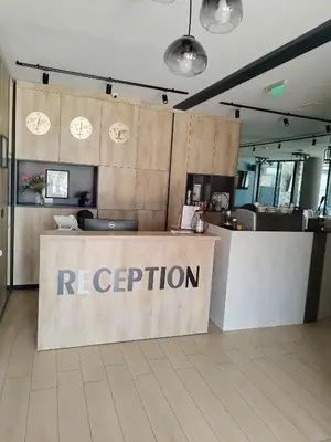 a reception area of a restaurant with a reception counter at Philippopolis Hotel in Plovdiv