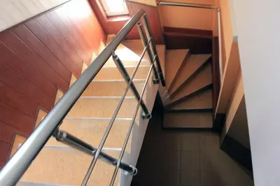 a spiral staircase in a building with wooden floors and a stair case at Osogovo Rooms in Sofia