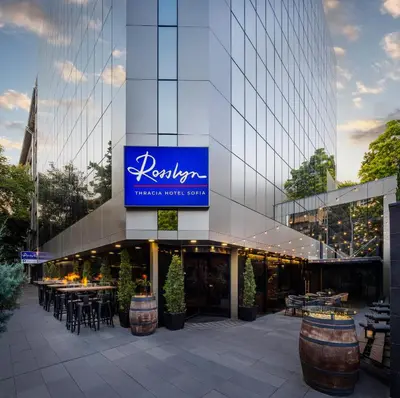 a building with a sign on the side of it at Rosslyn Thracia Hotel Sofia in Sofia