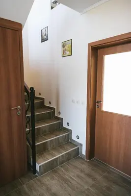 a staircase leading to a door in a building at Villa Maria, Complex Aleksandria in Dobrinishte