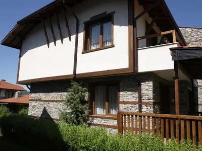 a house with windows and a wooden fence at Villa Maria, Complex Aleksandria in Dobrinishte