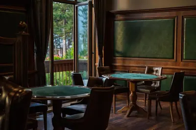 a classroom with two tables and chairs and a chalkboard at Maxi Park Hotel & Spa in Velingrad