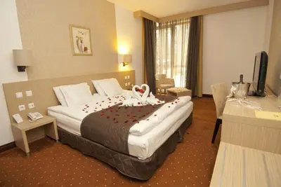 a hotel room with a large bed with decorations on it at Radina's Way Hotel in Borovets