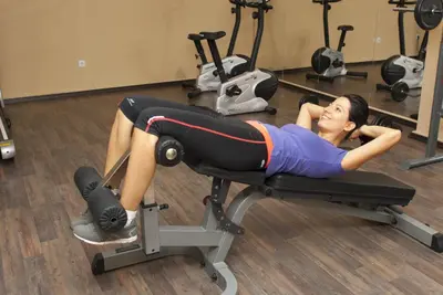 a woman laying on a reformer in a gym at Radina's Way Hotel in Borovets