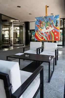 a room with couches and a painting on the wall at Hemus Hotel Sofia in Sofia