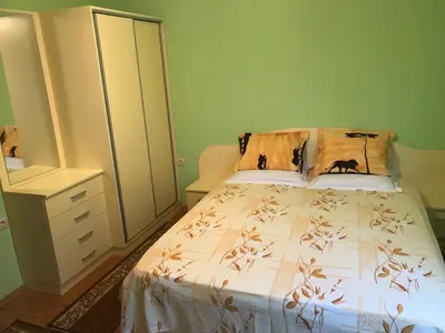 a bedroom with a bed and a dresser at Apartment Elena in Sandanski