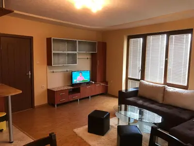 a living room with a couch and a tv at Apartment Elena in Sandanski