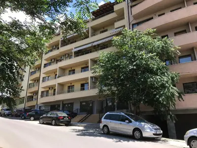 a white car parked in front of a building at Apartment Elena in Sandanski