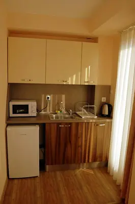 a kitchen with a sink and a microwave at Апарт Център Apart Center in Plovdiv