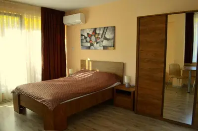 a bedroom with a bed and a sliding glass door at Апарт Център Apart Center in Plovdiv