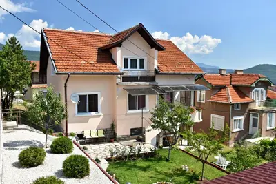 a house with red roofs and a courtyard at Saint Maria Guest House in Velingrad